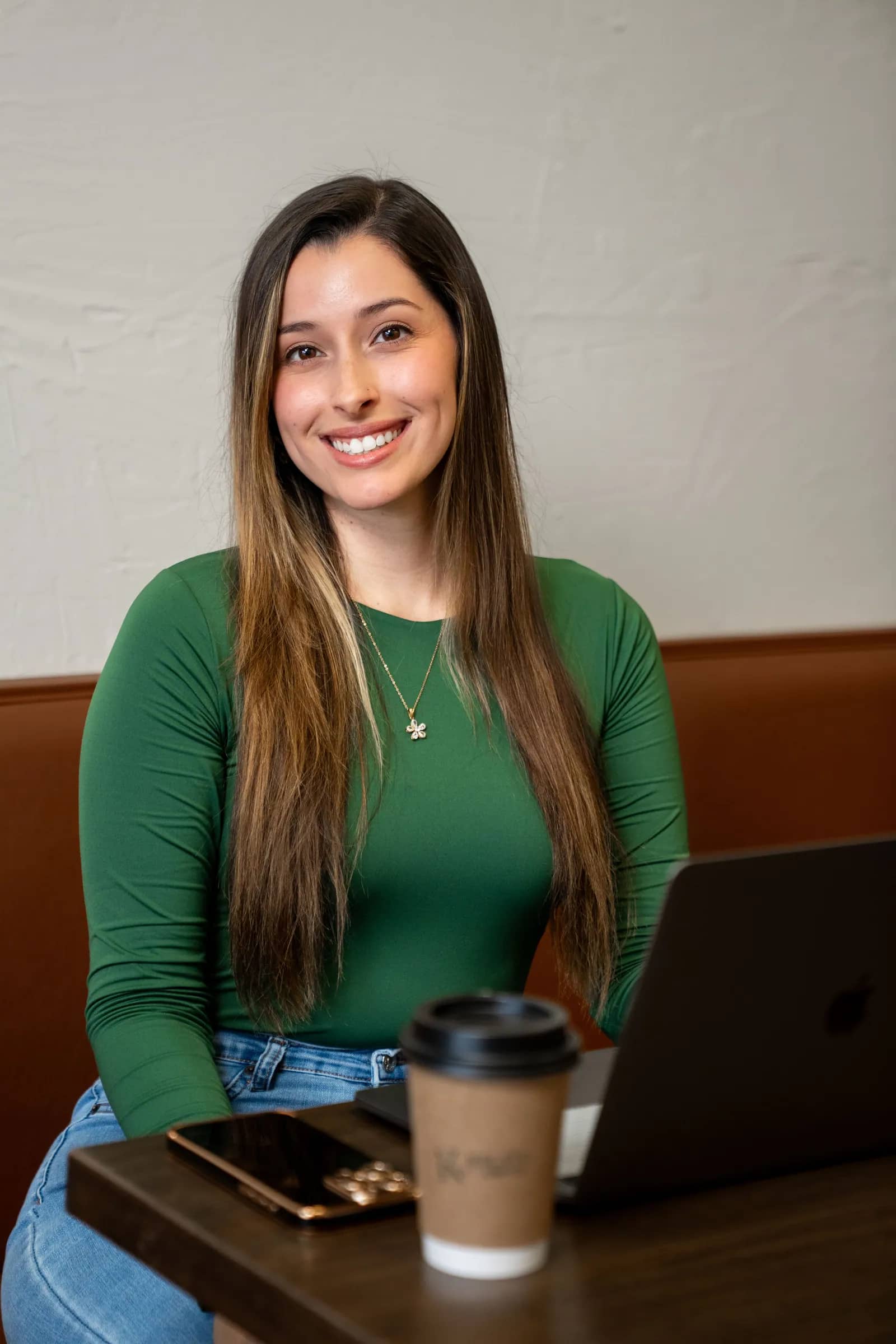 Jaclyn, founder of Drift & Bloom, in a green dress